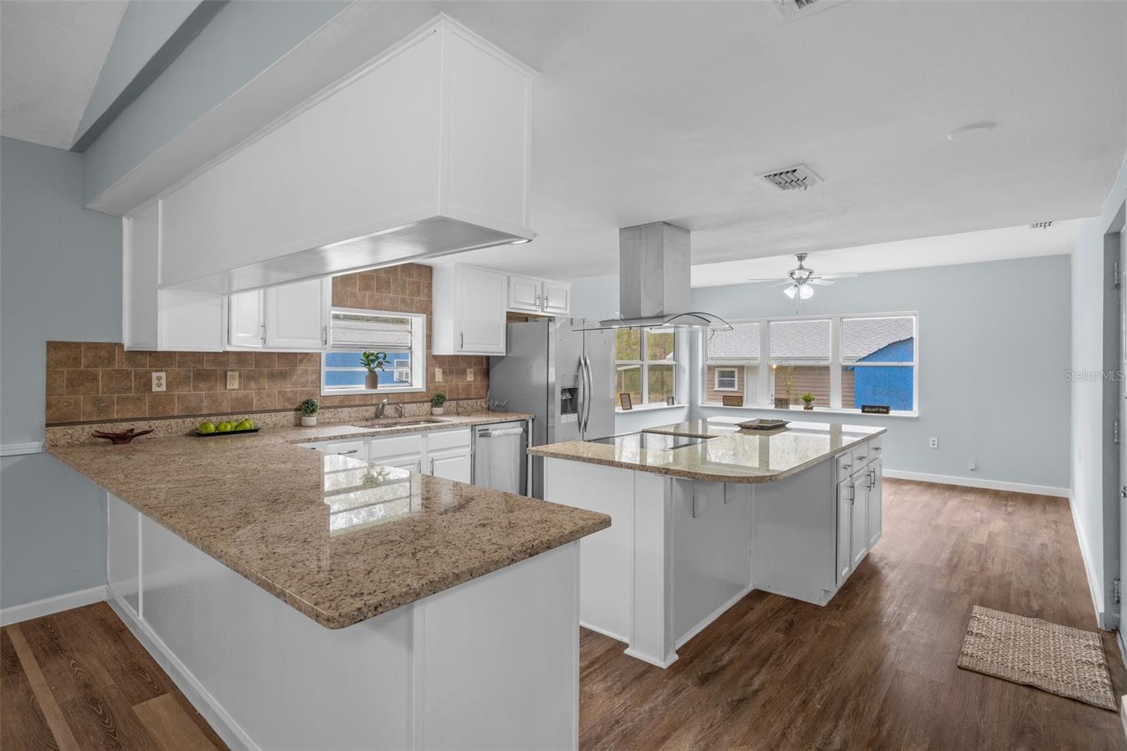 Notice the stunning granite counter tops and wonderful breakfast bar