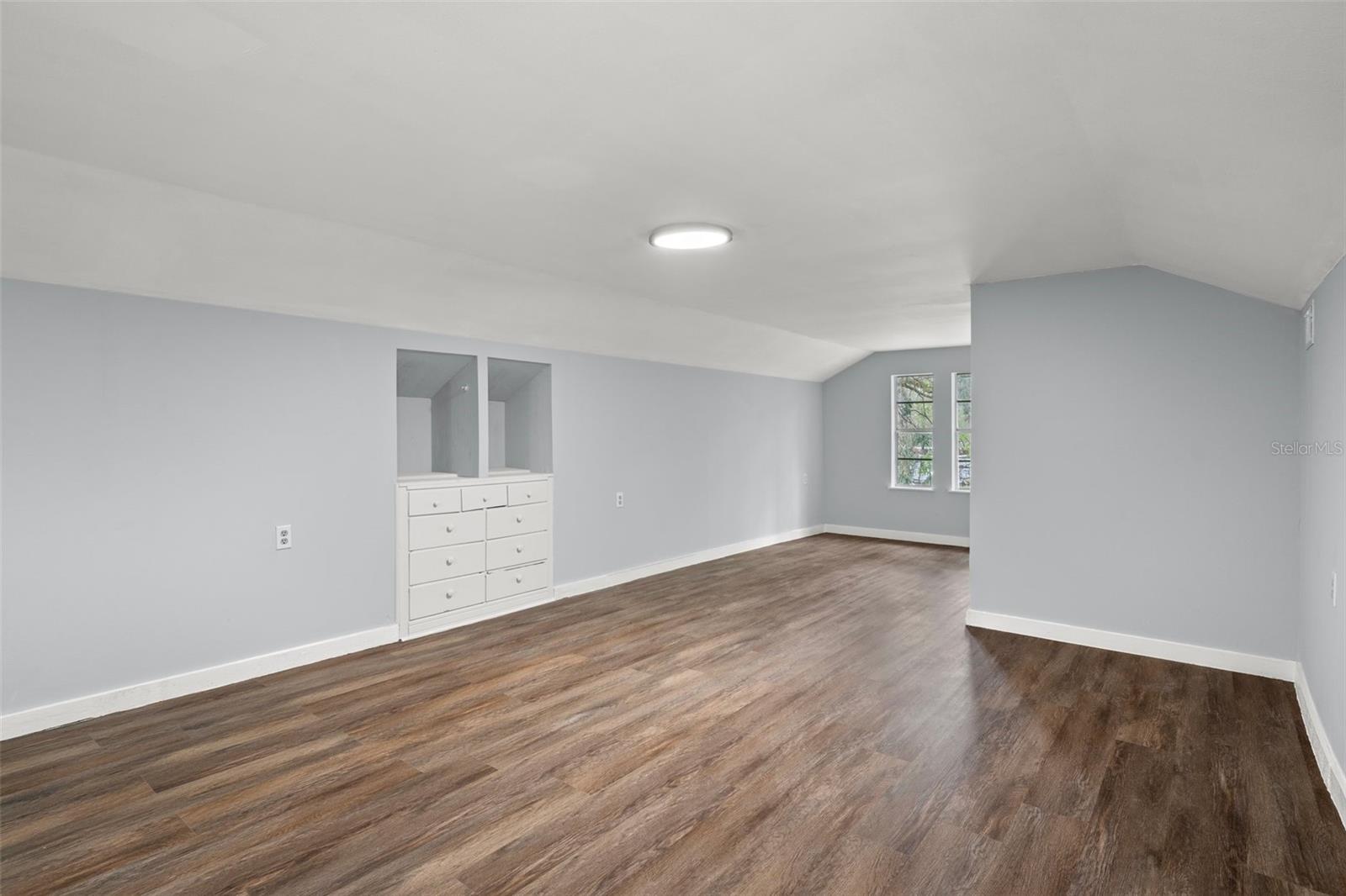 Another view of bedroom four with a built in dresser