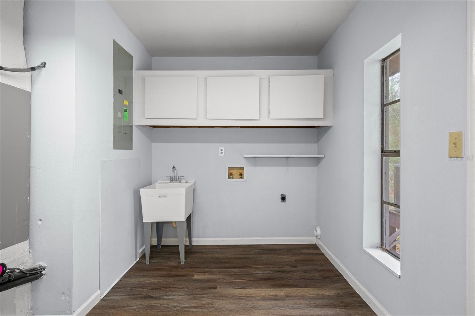 Inside Laundry Room with cabinets and a brand new sink