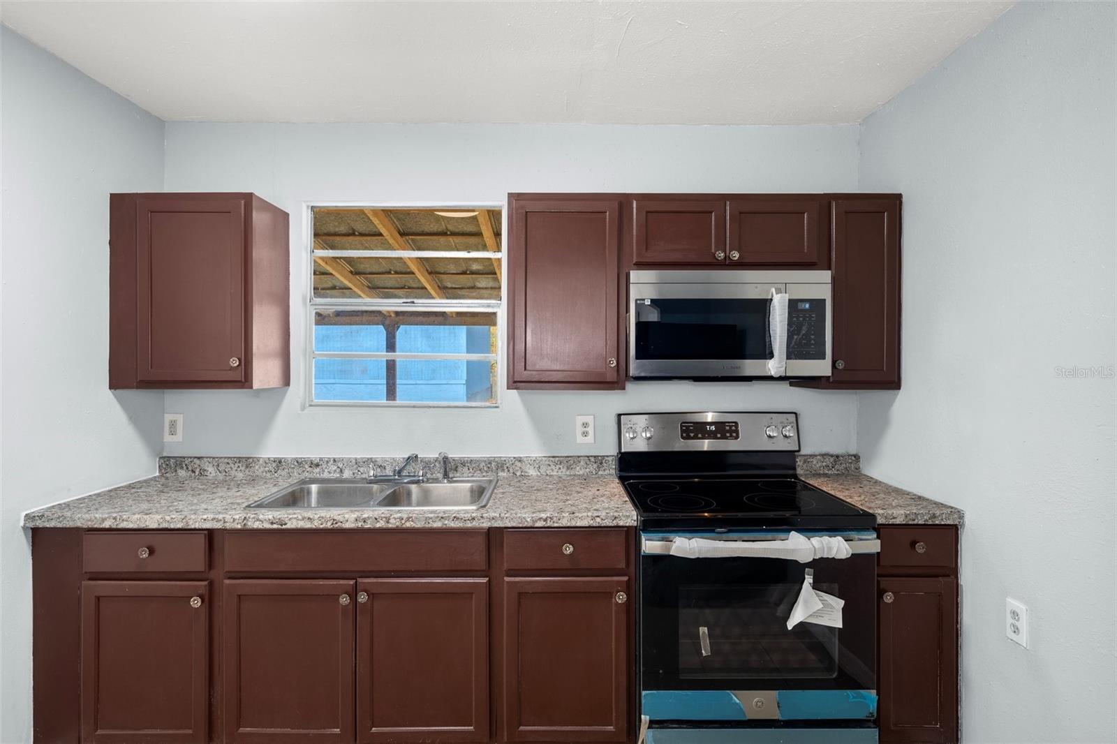 Close up of the kitchen with granite counter tops and brand new stainless steel appliances