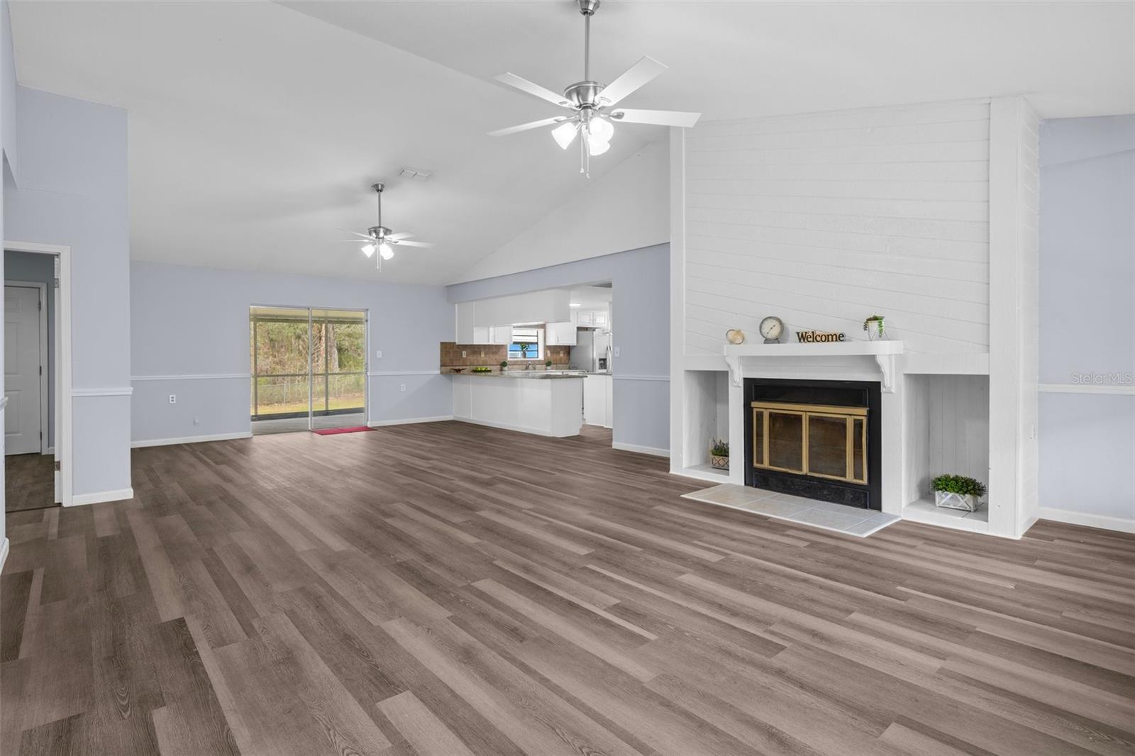 Wow, what a Beautiful Wood Burning Fireplace !! Notice the gorgeous waterproof vinyl plank floors throughout the home.