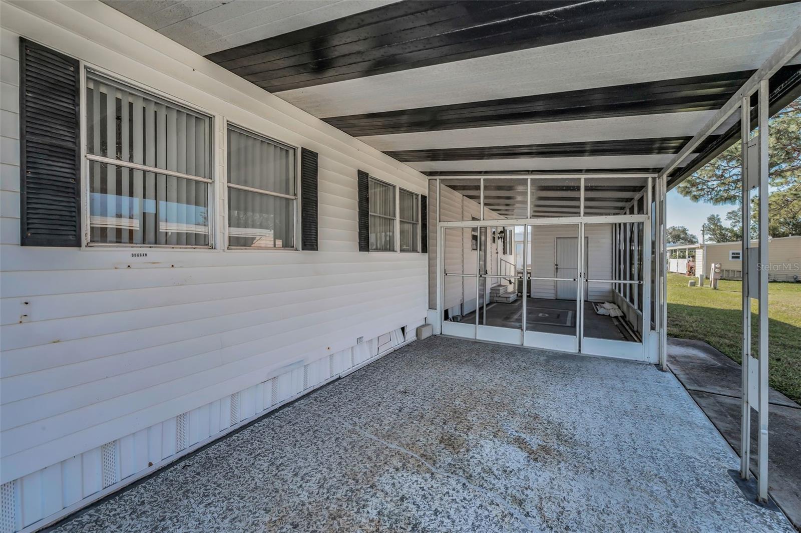 Carport & screened lana with side door entrance