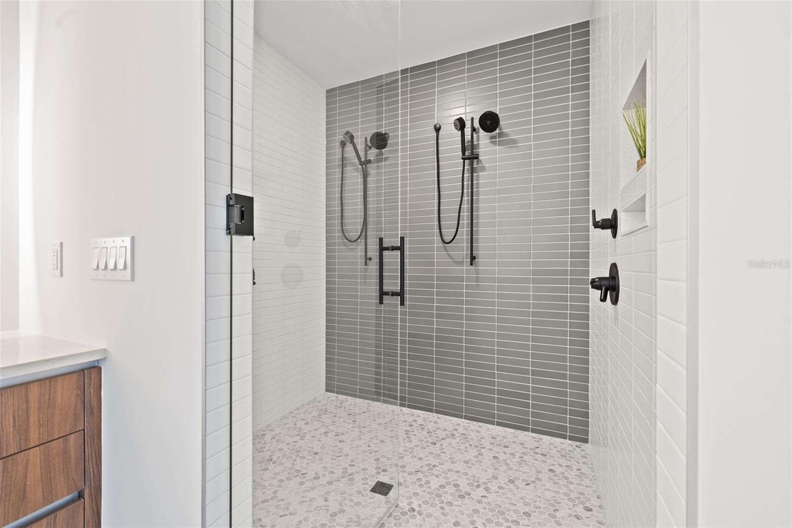 Large curdles walk-in shower with two shower heads and wands