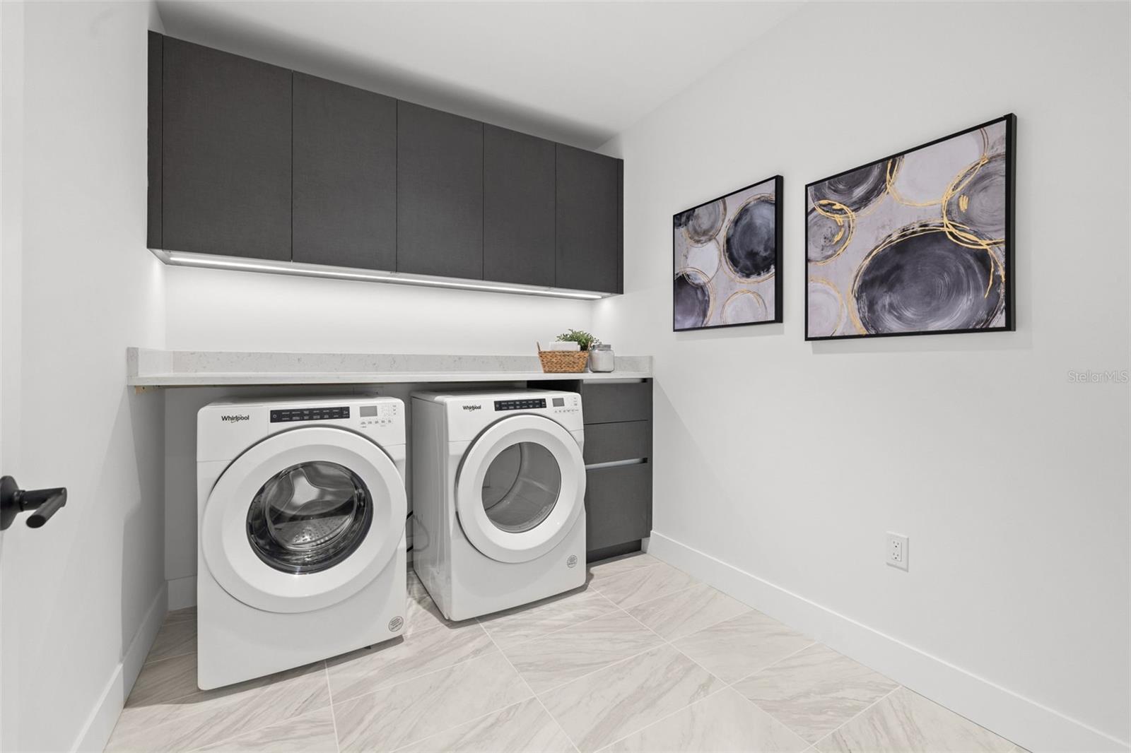 Incredibly large laundry room with lots of great storage and countertop!