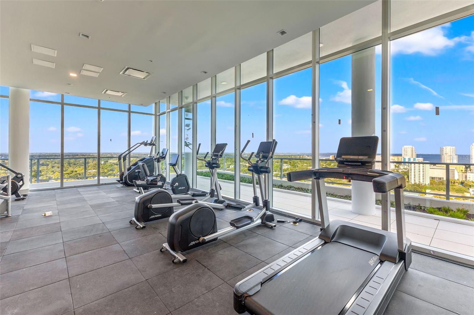 Rooftop fitness center with 3 full window walls with amazing views as you work out