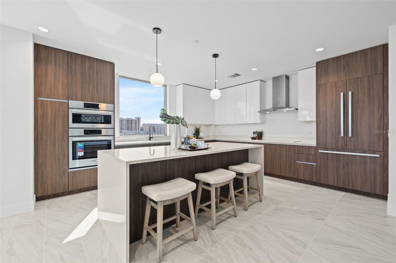 Chef's dream kitchen with walnut Italian cabinetry and quartz countertops