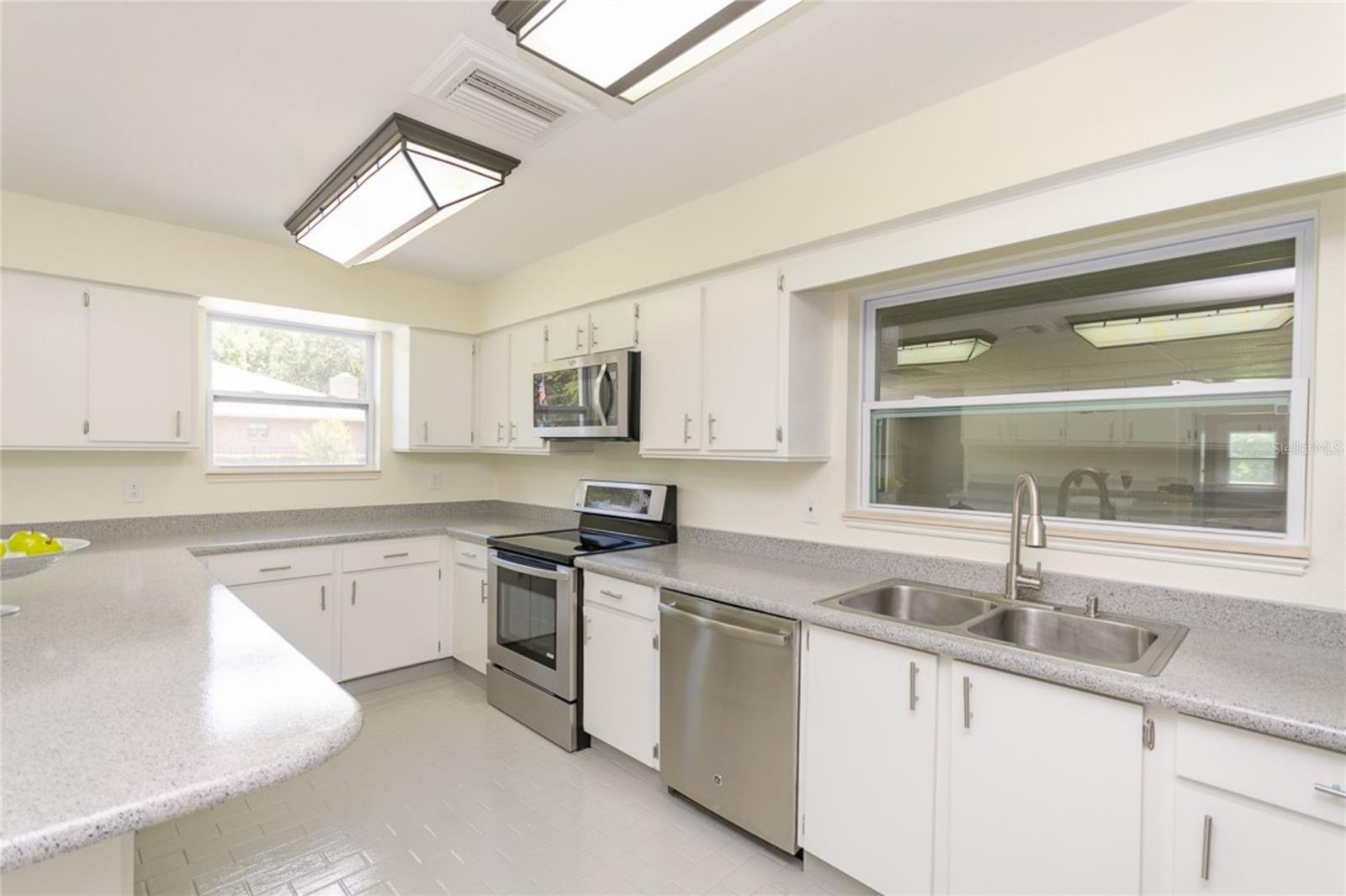 Kitchen – Sleek White Cabinets & Ample Counter Space