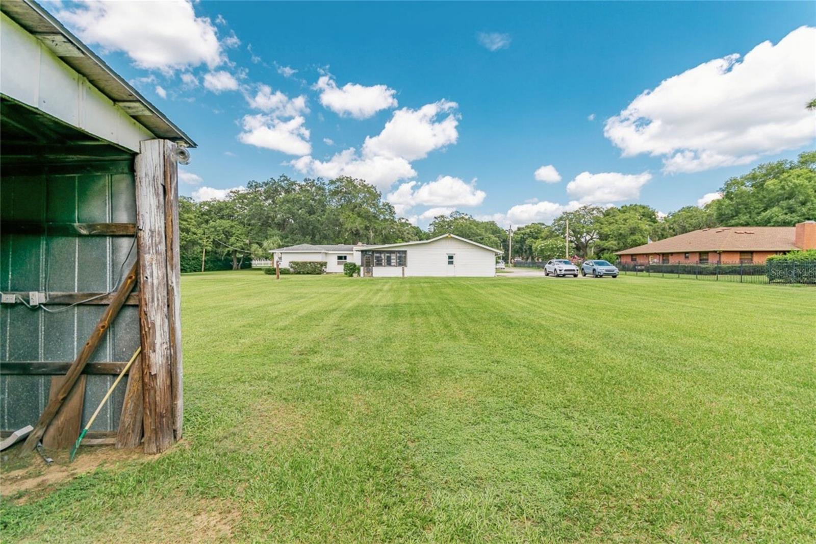 View from Barn Toward House – Spacious Acreage