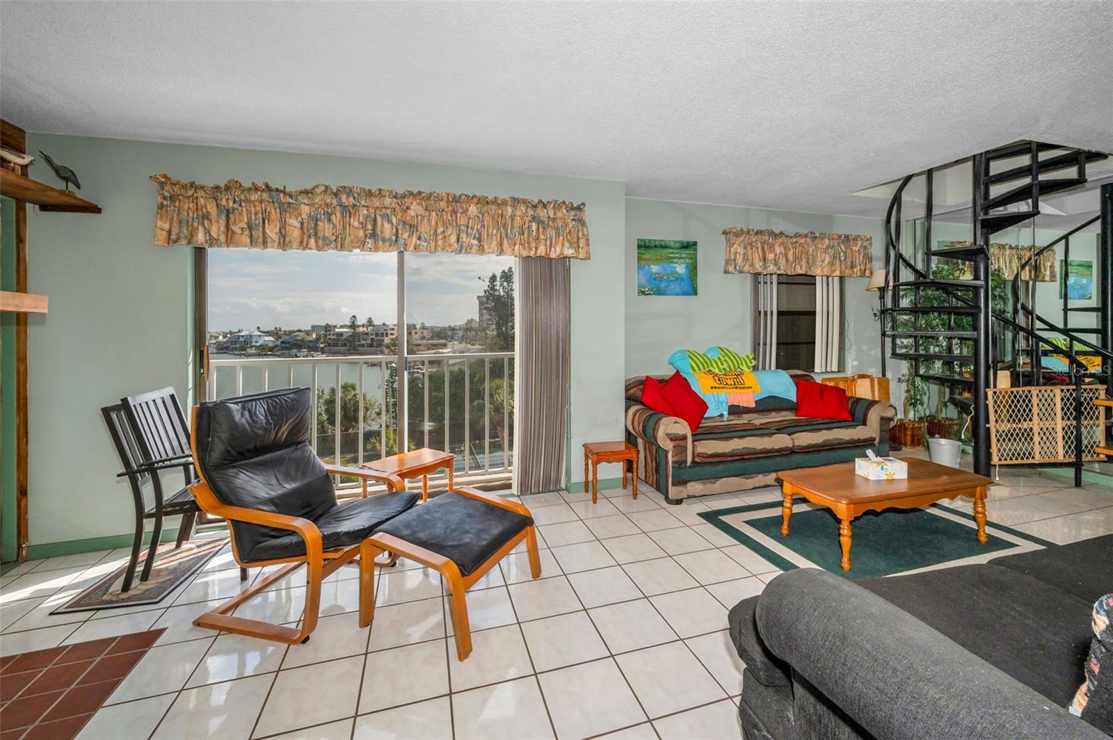 Sun Filled Living Room with spiral staircase to your own private rooftop Oasis!