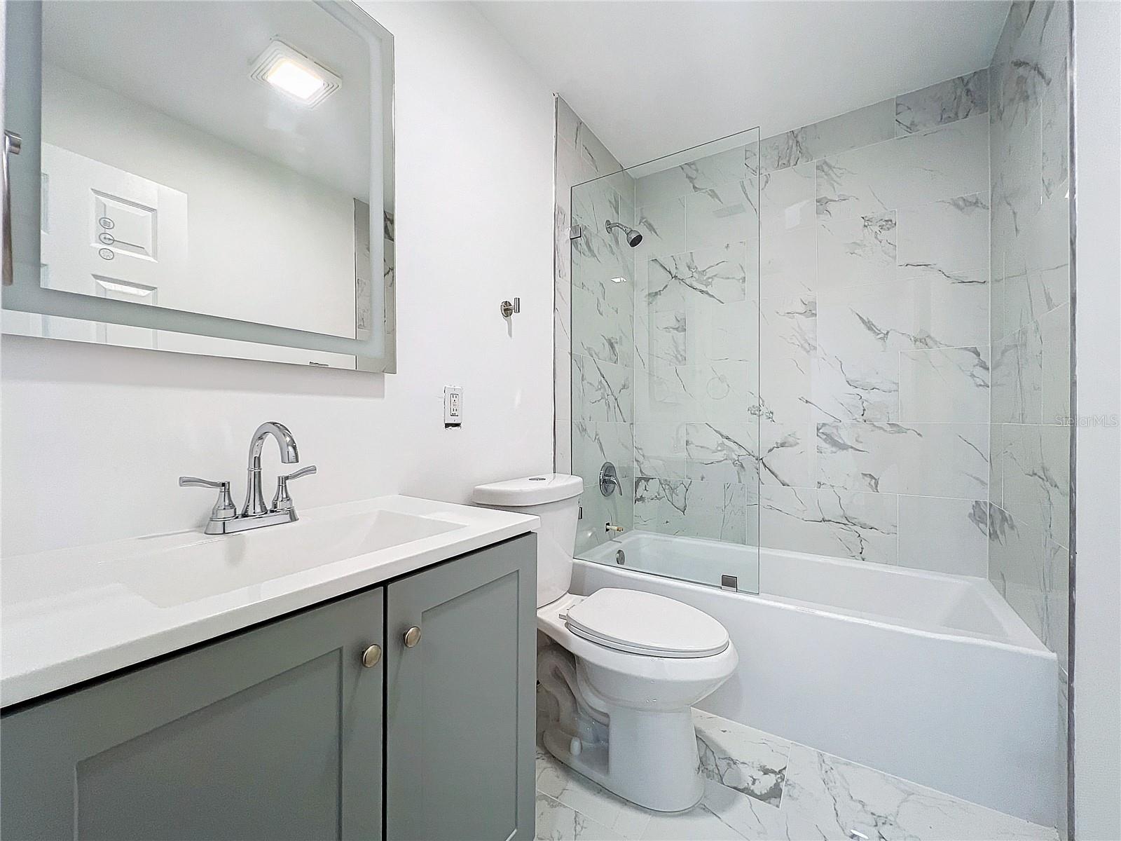 Bathroom 2 Upstairs Complete Remodel, Matte Gray Vanity Cabinet, Heated / LED Mirror.  New Tub, white tile throughout