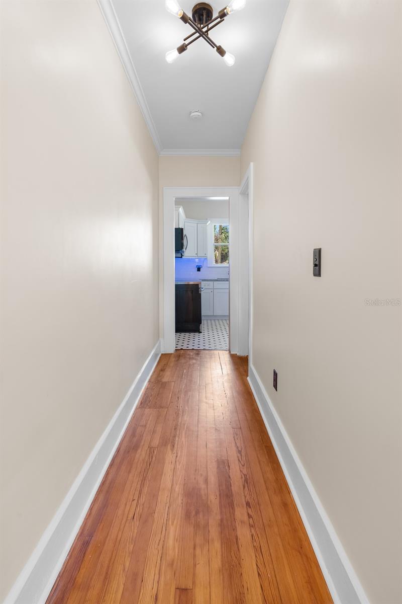 Hallway leading to kitchen and third bedroom (on right).