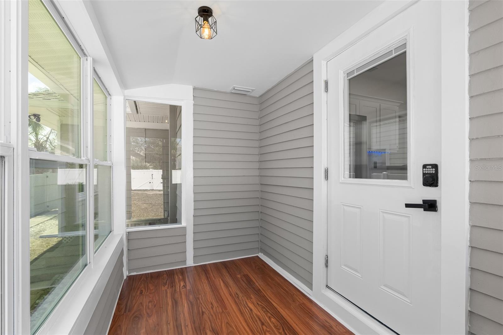 Small enclosed porch leading to kitchen.