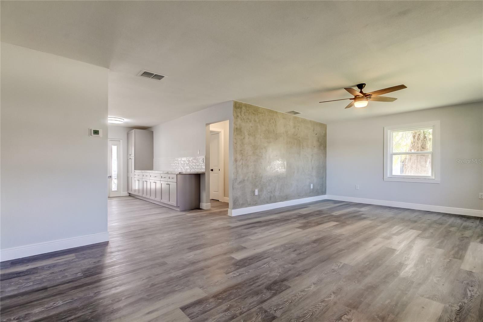 Enter via Living Area.. Custom Venetian Accept Wall Sets the Stage for Luxury, Taste, & Style for this Newly Renovated Home!!