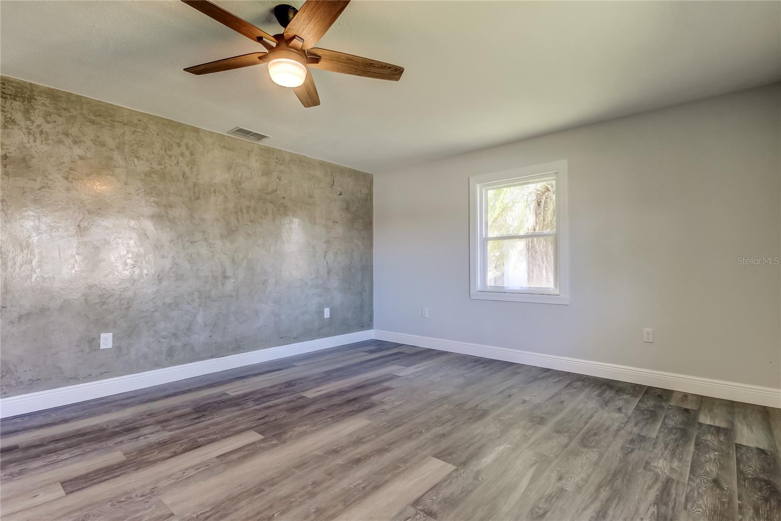 Living Room (14' x 23.7')  w Venetian Plaster Accent Wall Adds Luxury & Dimension to Your Living Room..