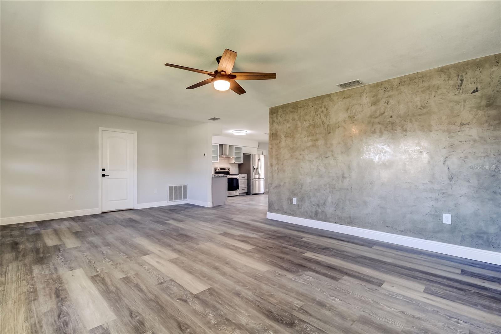 Living Room (14' x 23.7') Features a Classy Venetian Plaster Accent Wall That Steals the Show as soon as you Enter the Home!