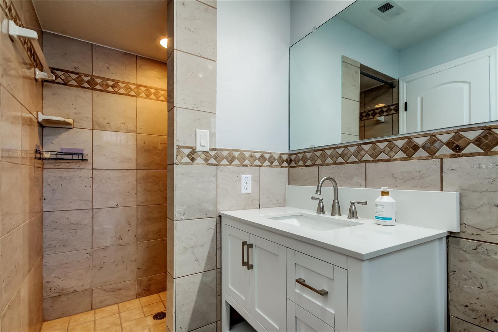 Owners Retreat Bathroom (4.10' x 9') Offers Walk in Shower, New Vanity, & Spaciousness..