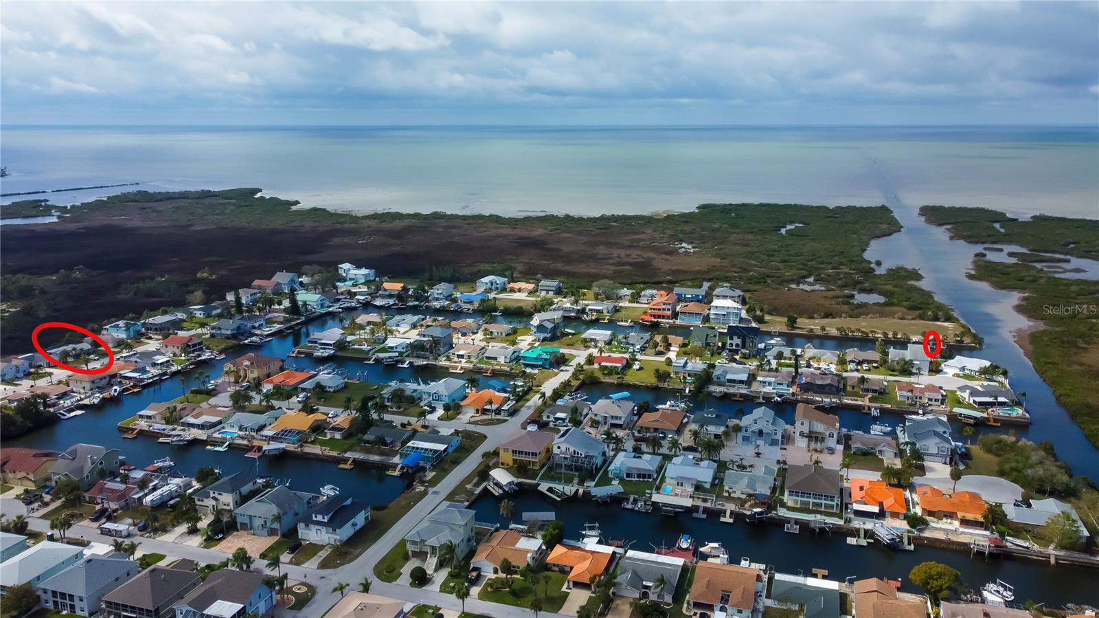 Aerial Showing the Home, the Boat Ramp, & Private Deeded Boat Slip that Conveys with the Home! The Gulf is Minutes Down the Canal...