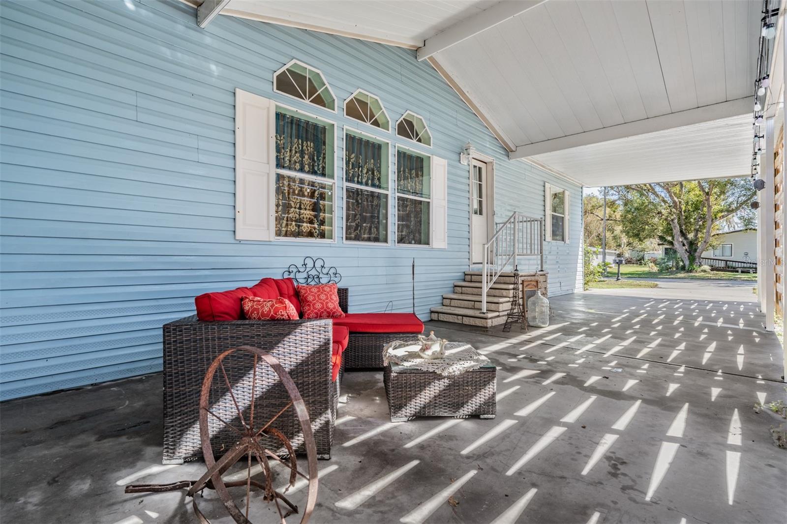 Leisure space to visit with guests with edison lights on Carport