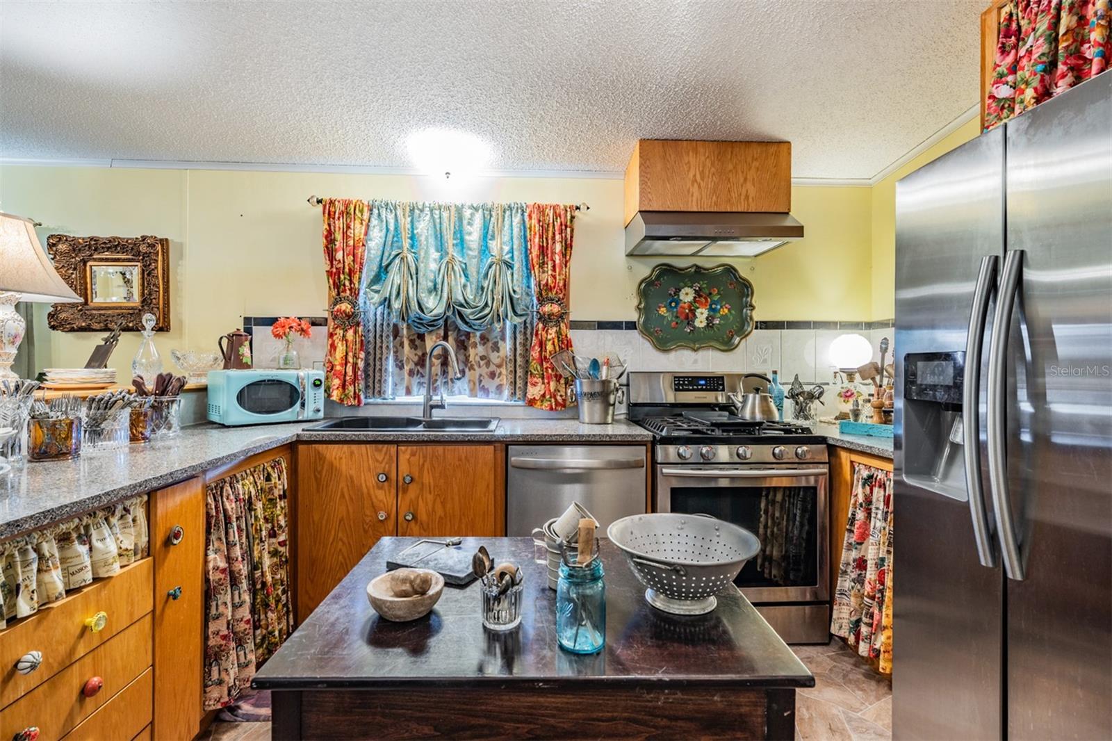 Center island is movable and cabinet doors are in shed when curtains are removed