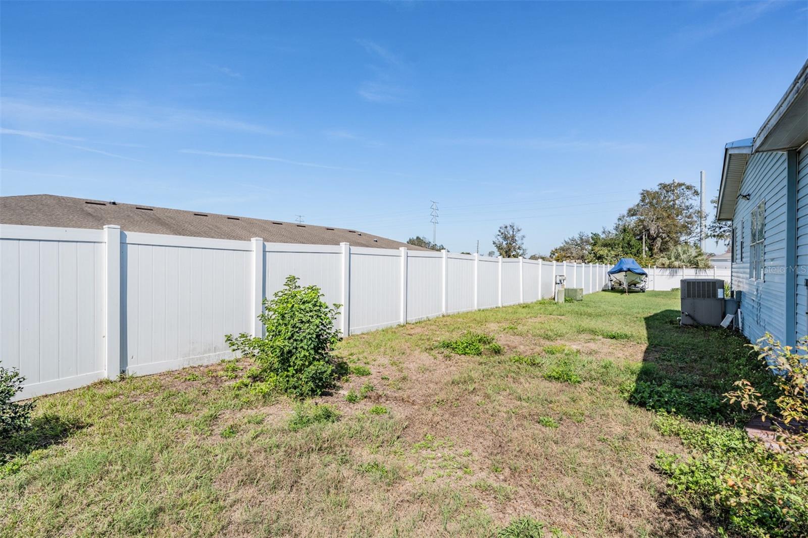 Private backyard with PVC fence at rear