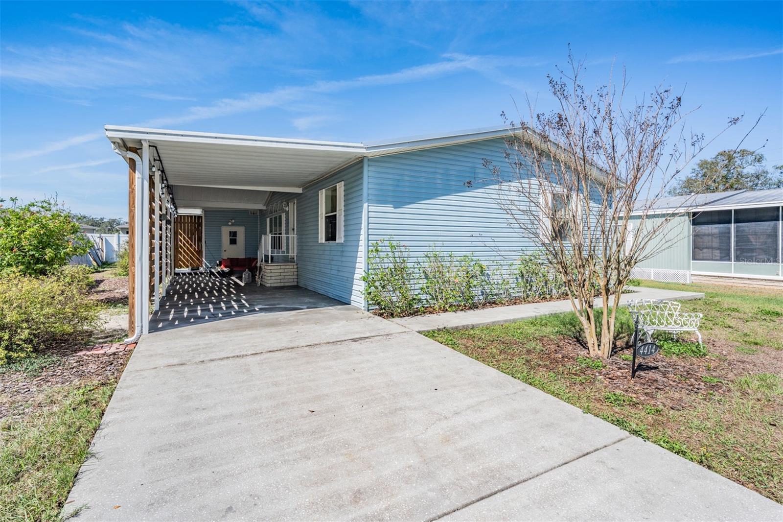 one car carport with elongated driveway