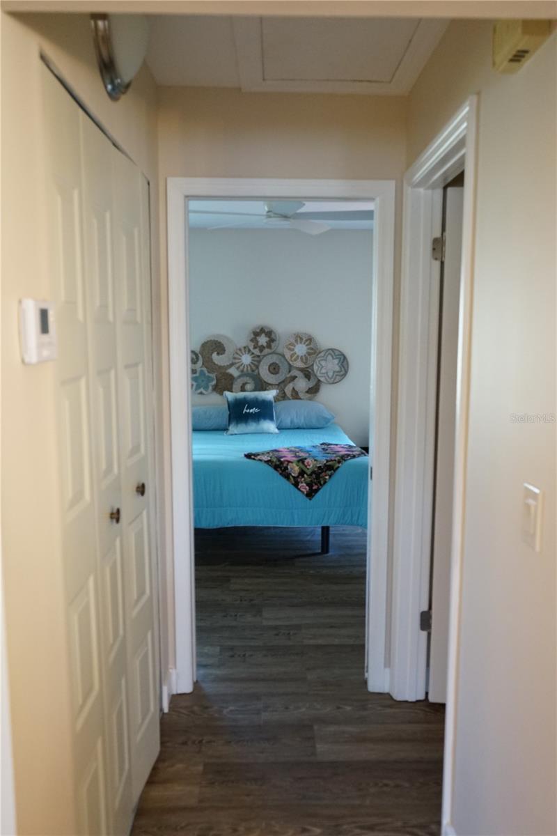 hallway has pantry on the left and half bath on the right then into the bedroom