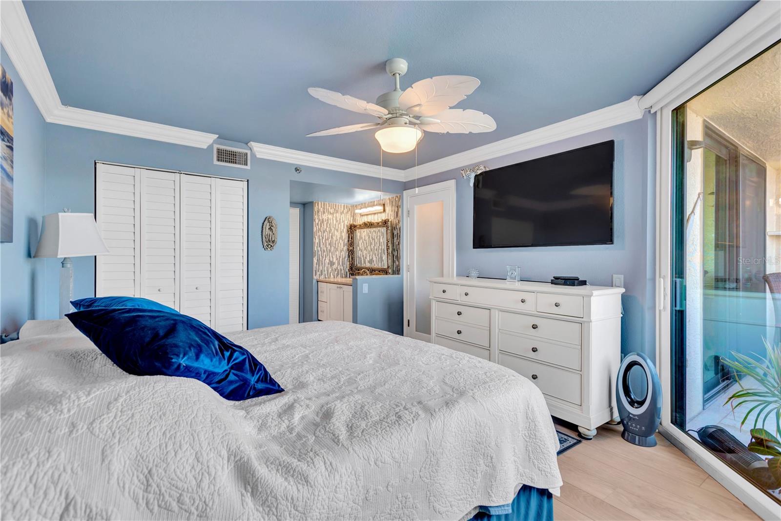 Wow!! Spacious en-suite Master Bedroom offers built in closet, beautiful crown molding & baseboards, tropical leaf fan/light as well as sliders that open onto your waterfront balcony.