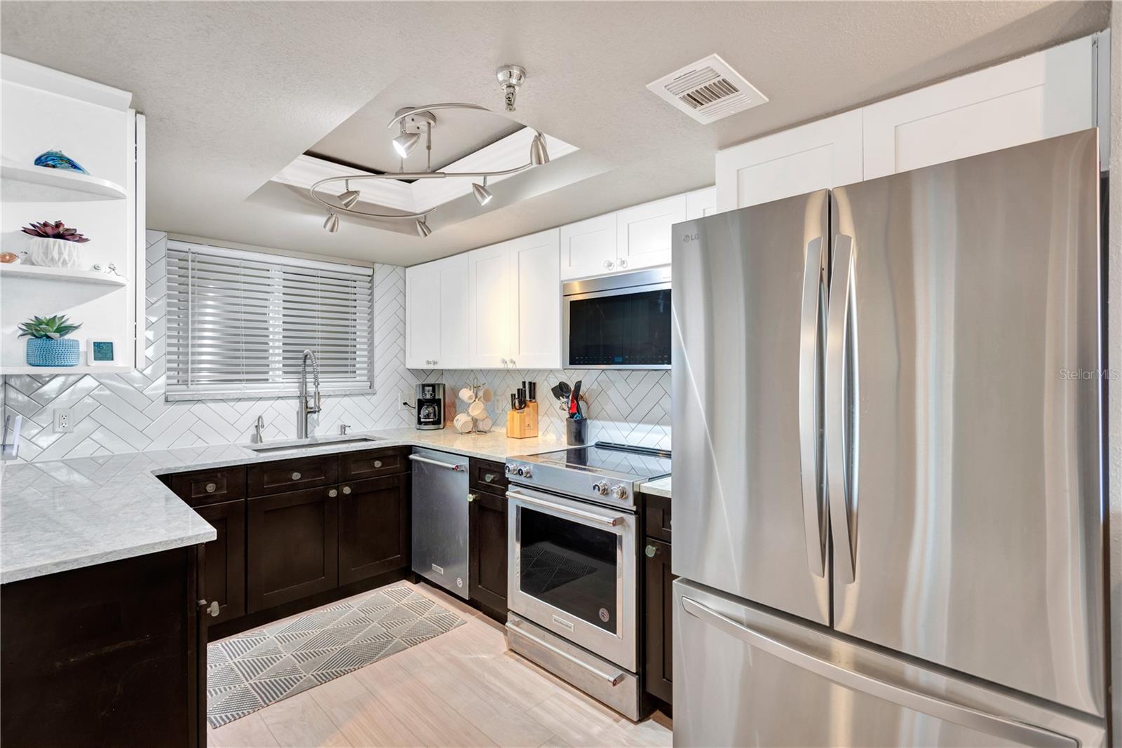 Exquisite, sparkling kitchen with state of art stainless steel appliances. Notice the contemporary designer lighting.