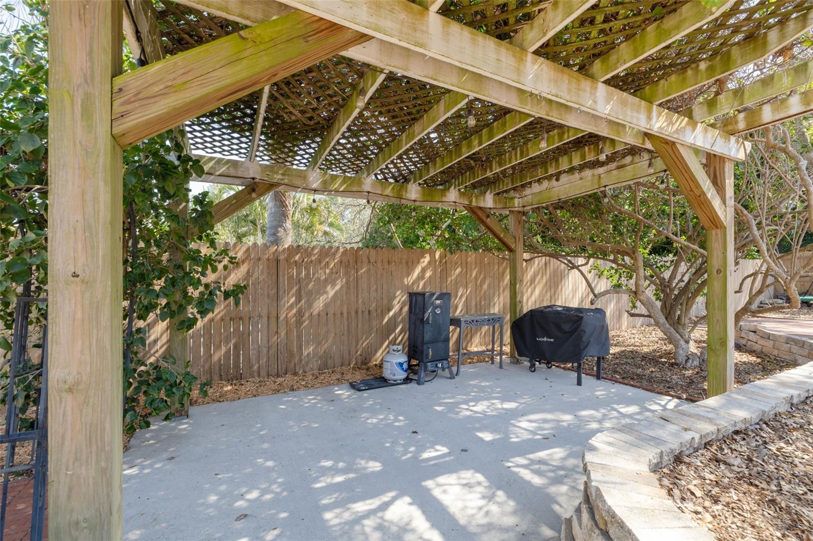 Outdoor grilling area under the pergola