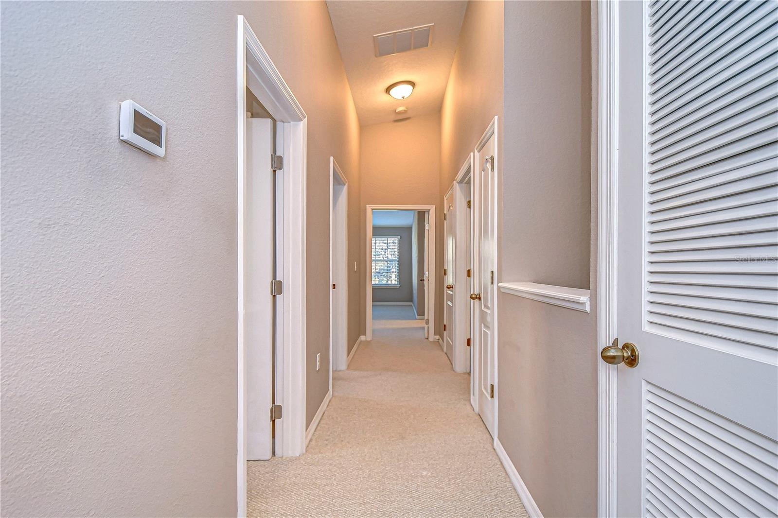 Navigate through this inviting hallway leading to your cozy sanctuary