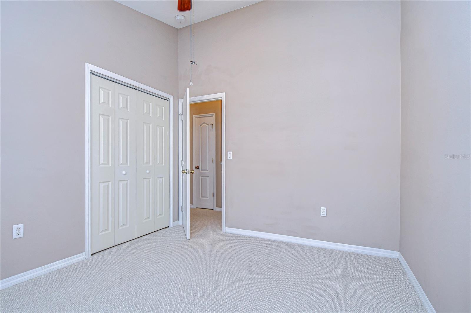 his inviting third bedroom features a spacious closet and soft neutral tones