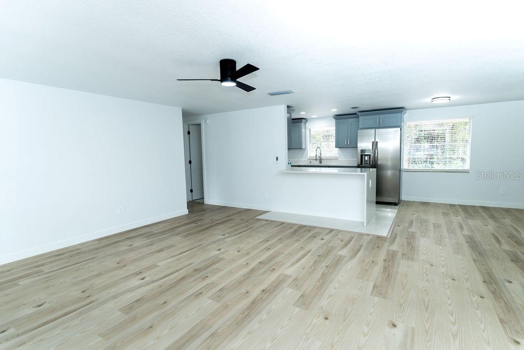 OPEN LIVING ROOM  KITCHEN  WITH PENINSULA FOR SOME CUTE BARSTOOLS