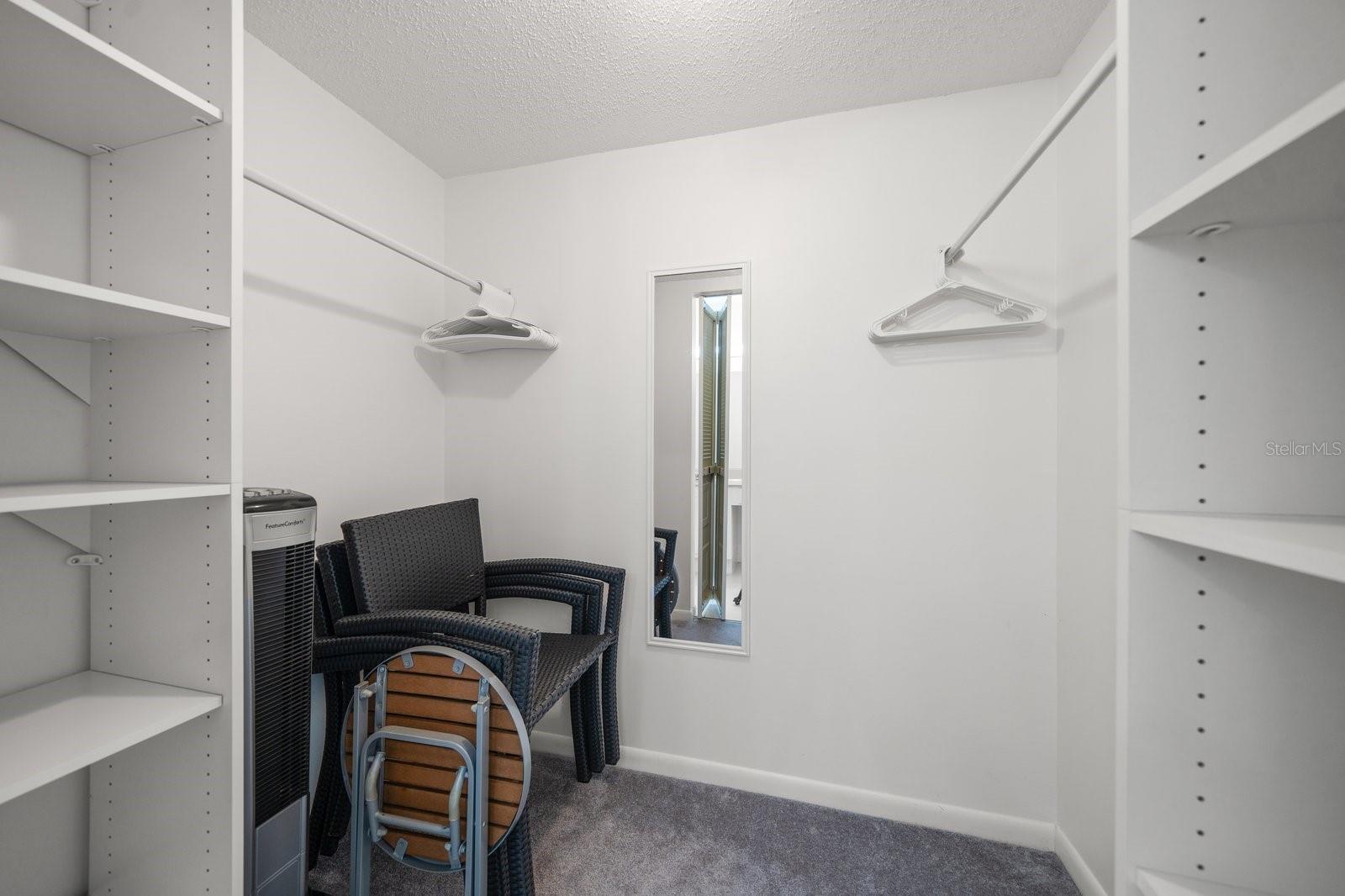 Primary bedroom walk-in closet