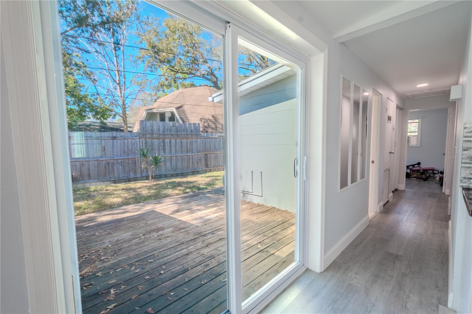 Sliding glass doors lead to a rear deck/patio.