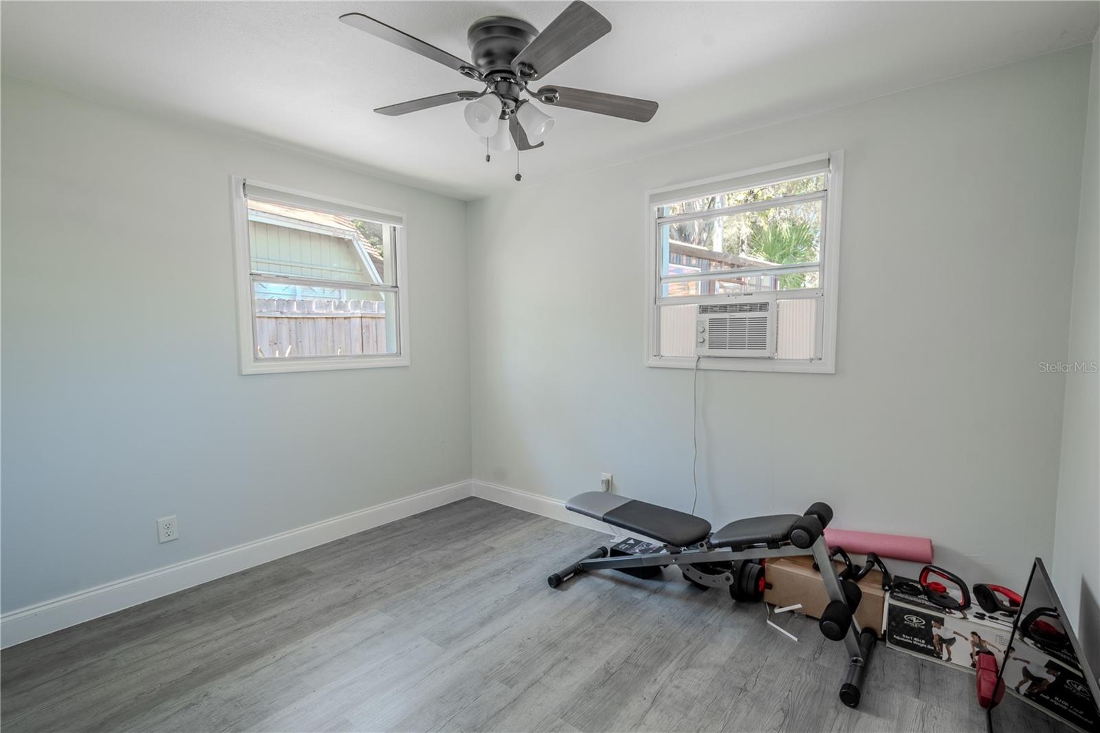 Bedroom 3 features vinyl flooring, a ceiling fan with light kit and a built in closet.