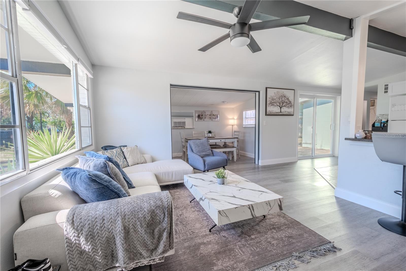 The dining room features neutral tones and vinyl flooring.