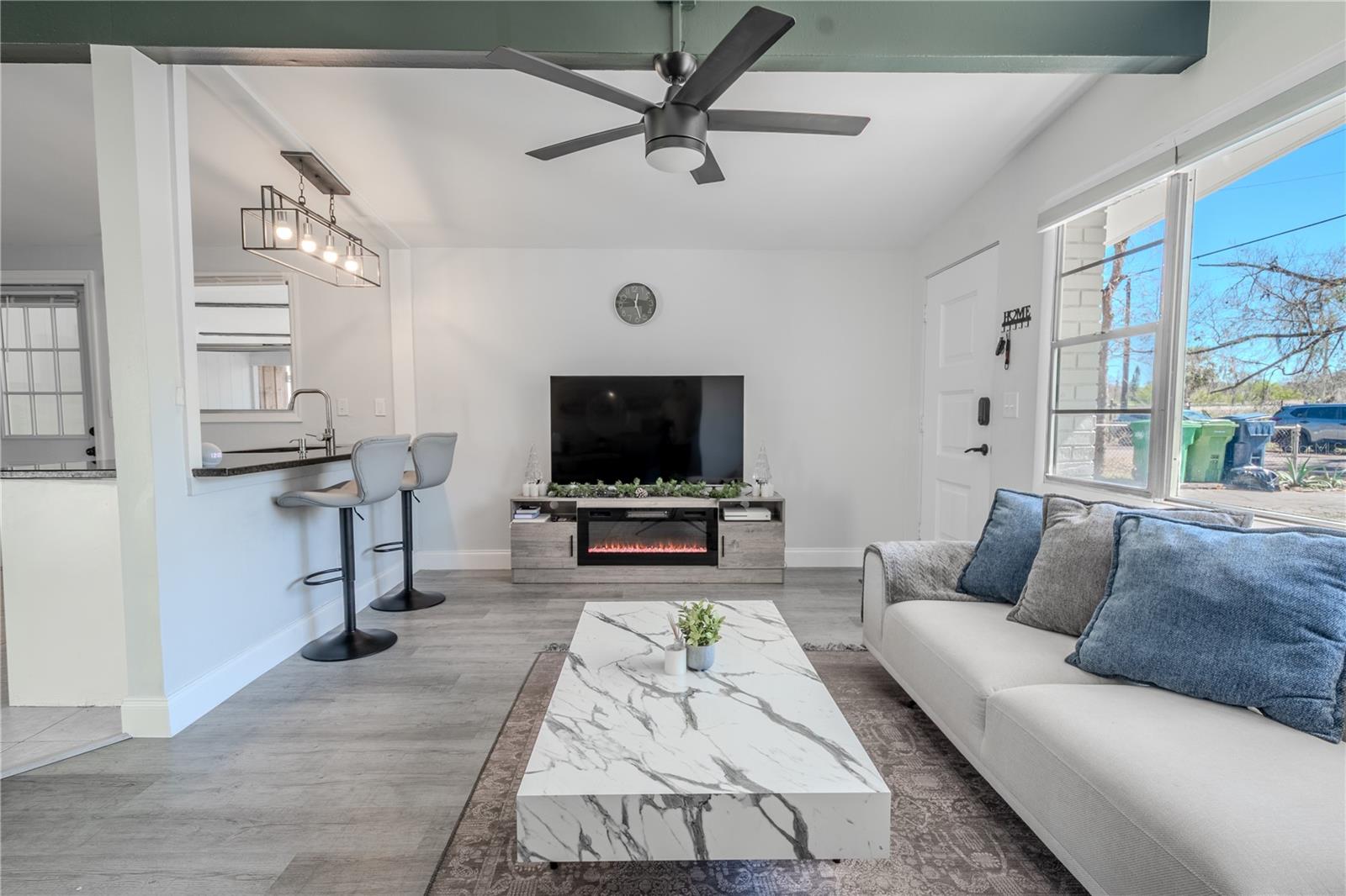 The living room is open to the kitchen and breakfast bar.