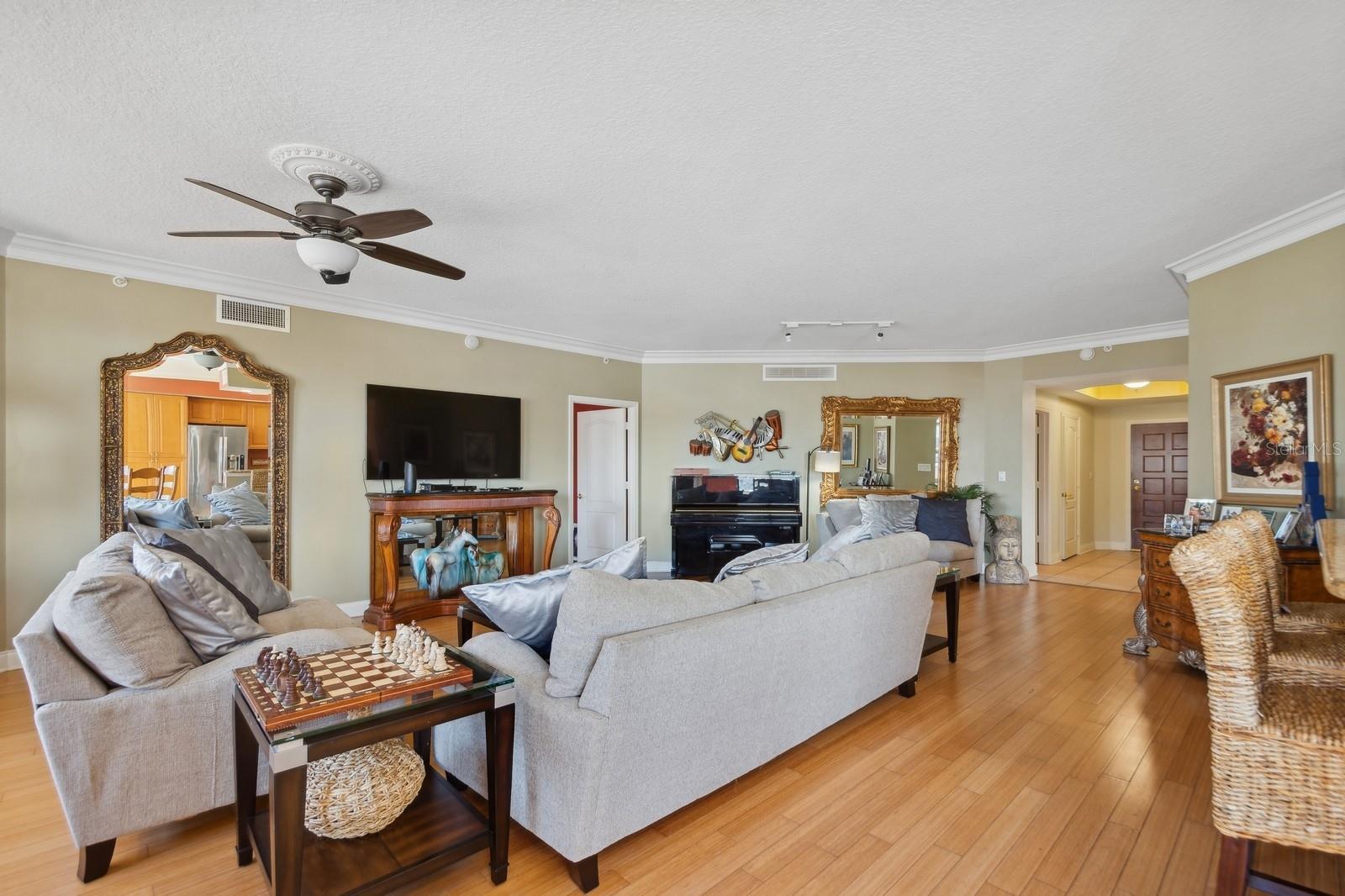 The dining area is currently occupied by a Piano and large mirror.