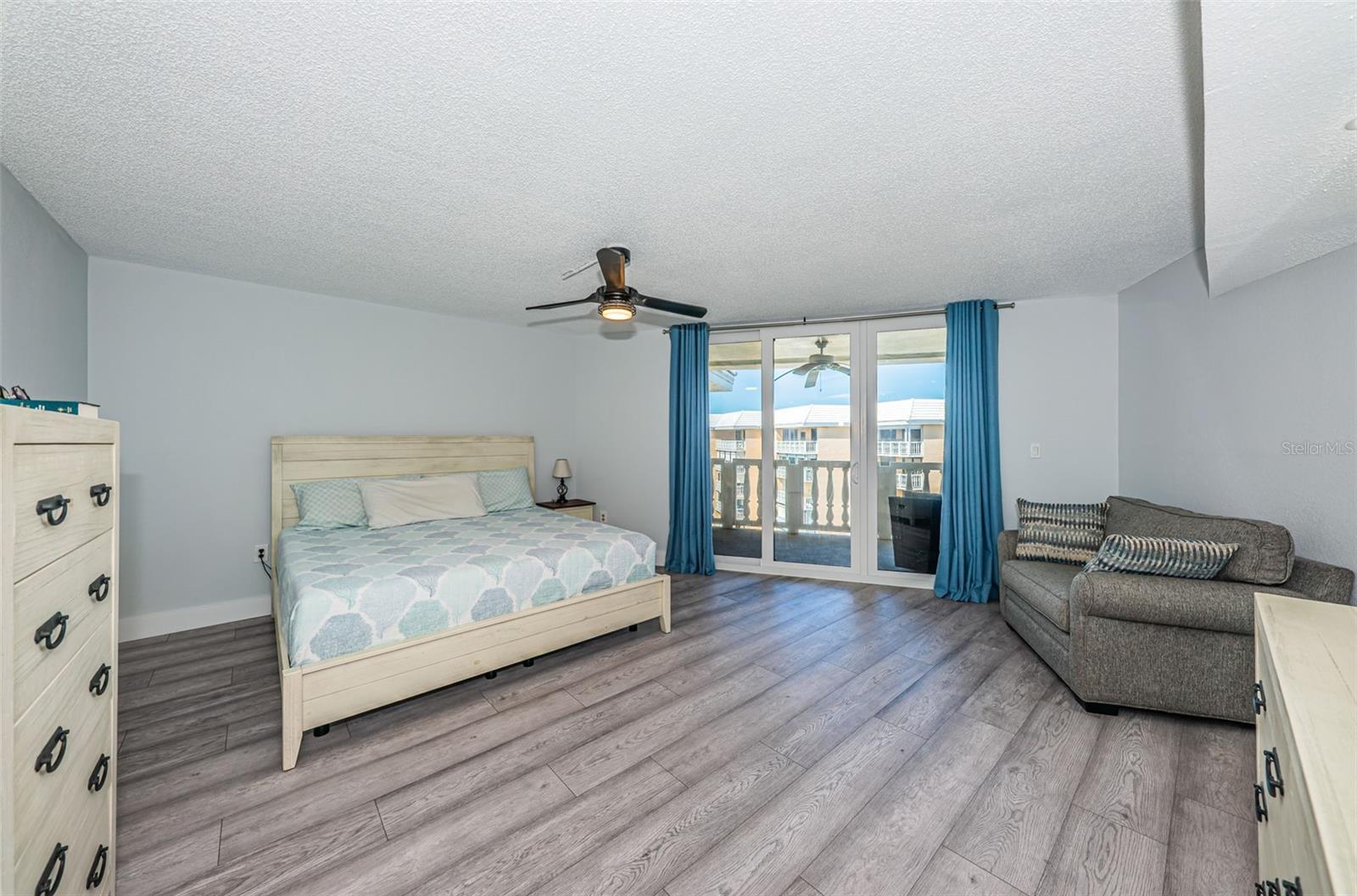 Primary bedroom with slider to main balcony