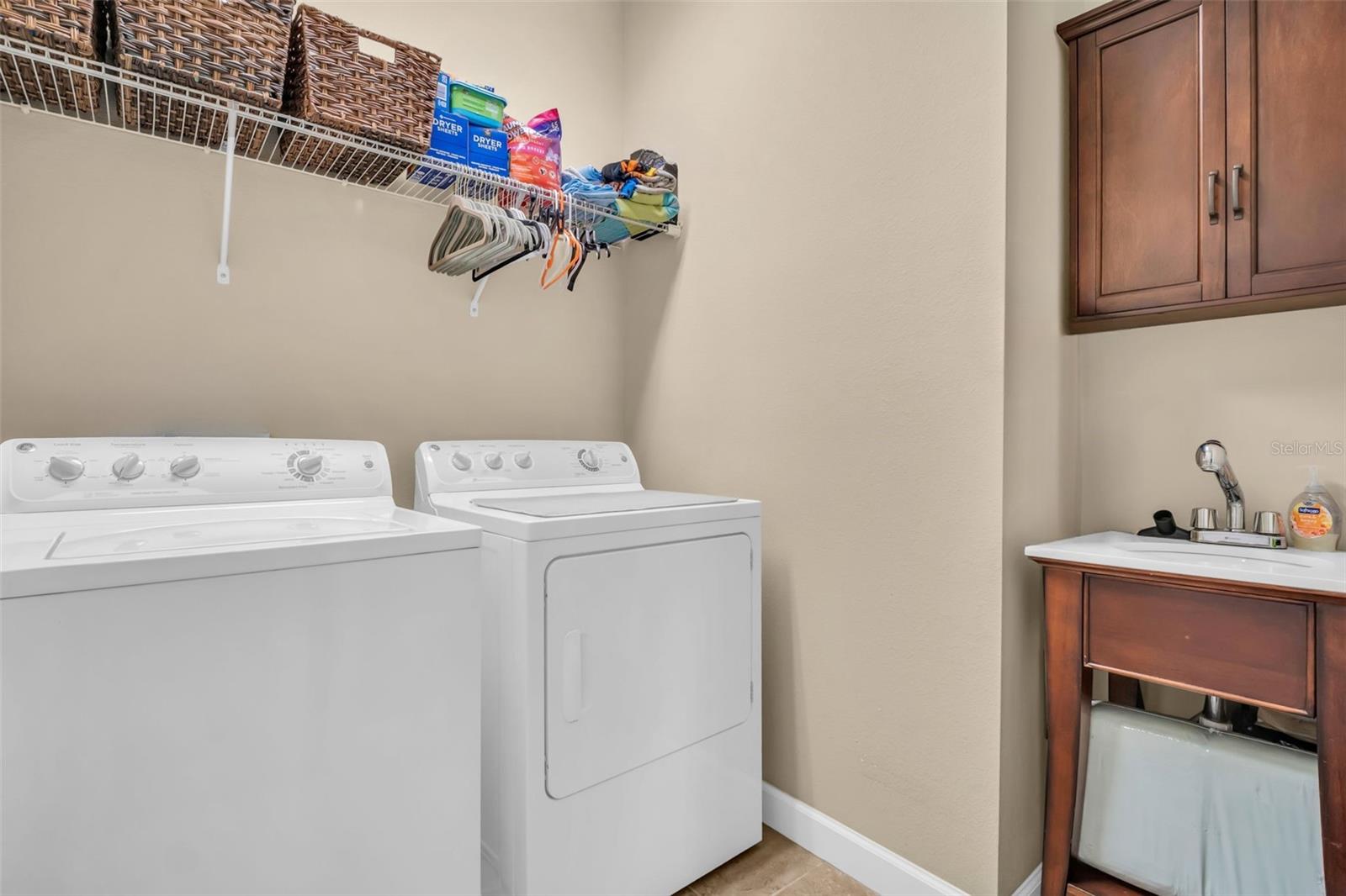 Laundry room is conveniently located on the second level with all bedrooms plus a custom utitlity sink & additional storage~