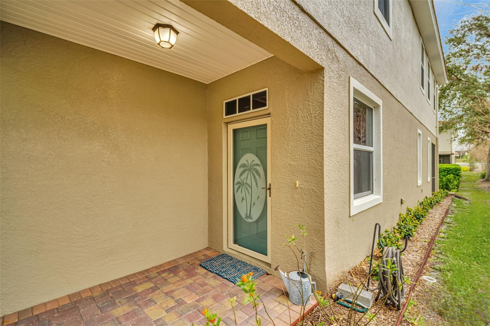 Welcoming front entry with an updated vinyl plank ceiling & a beautiful storm glass door~