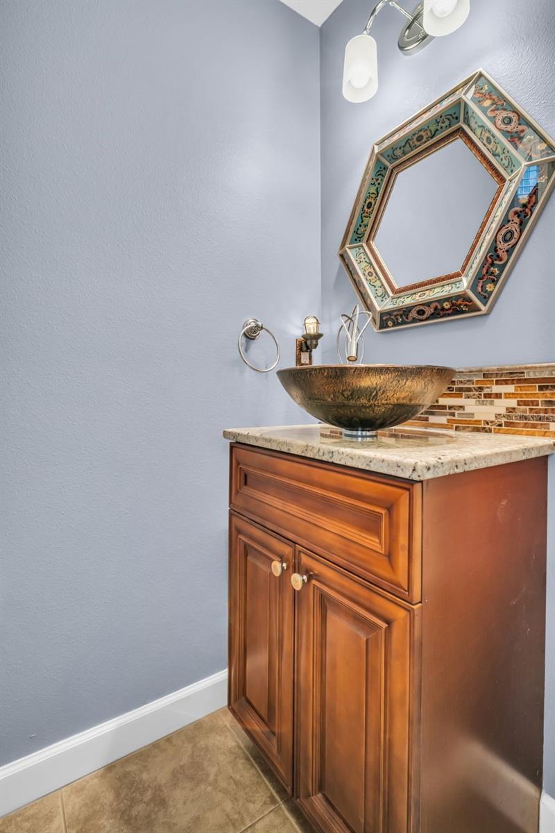 Gracious half bath conveniently located between entry and main living~