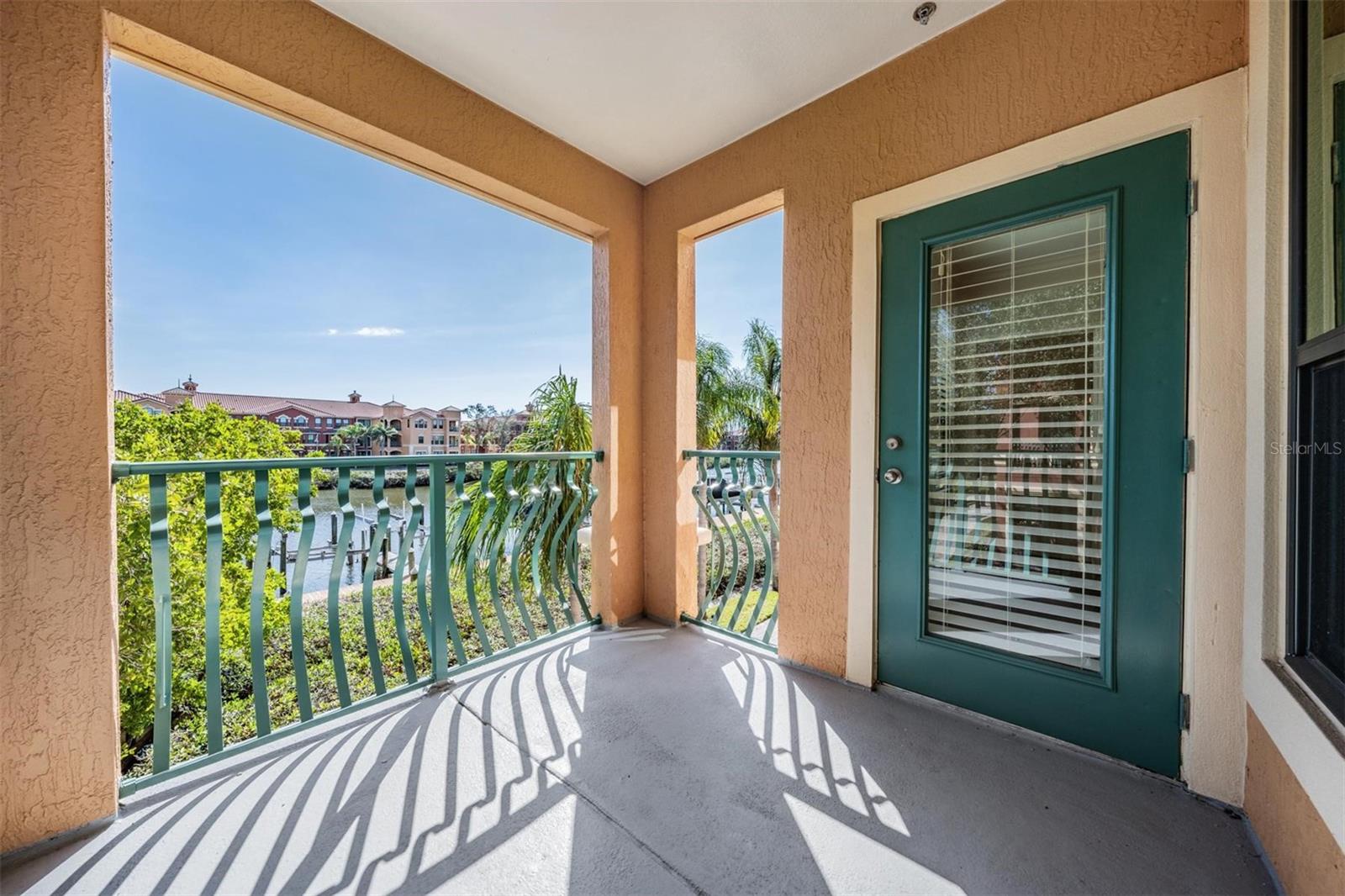 Second floor patio off primary bedroom with breathtaking water views!