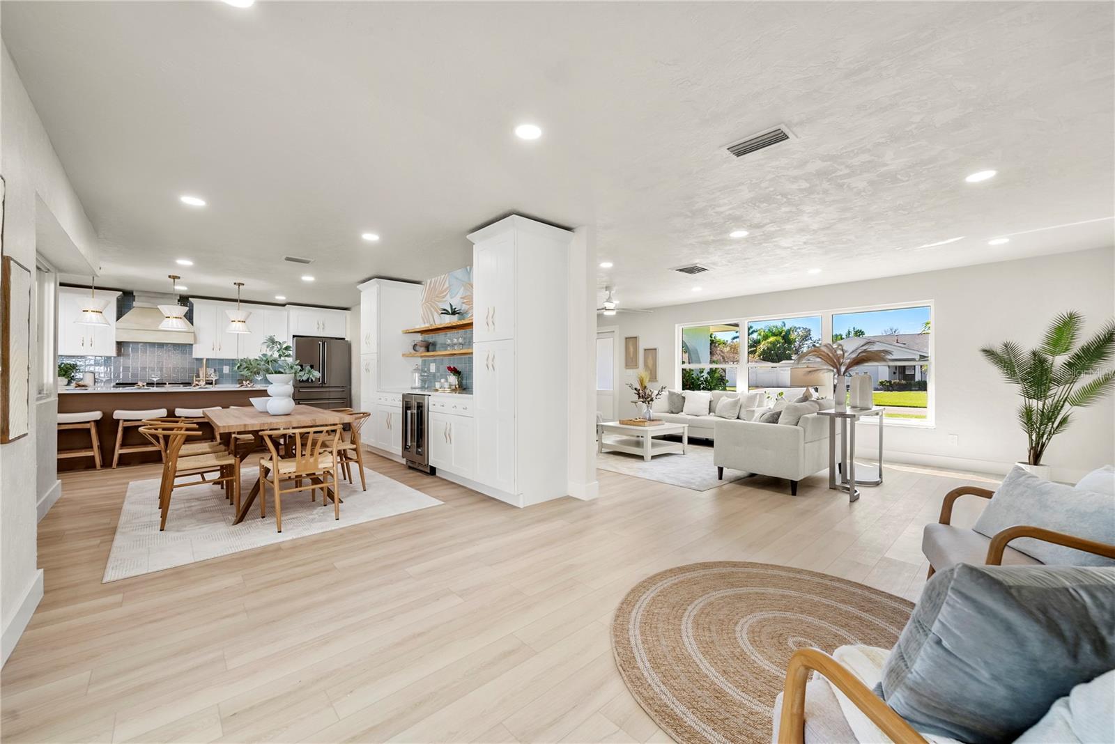 View from back of the house to the view of the open dining area and kitchen view/ living room and view of front windows