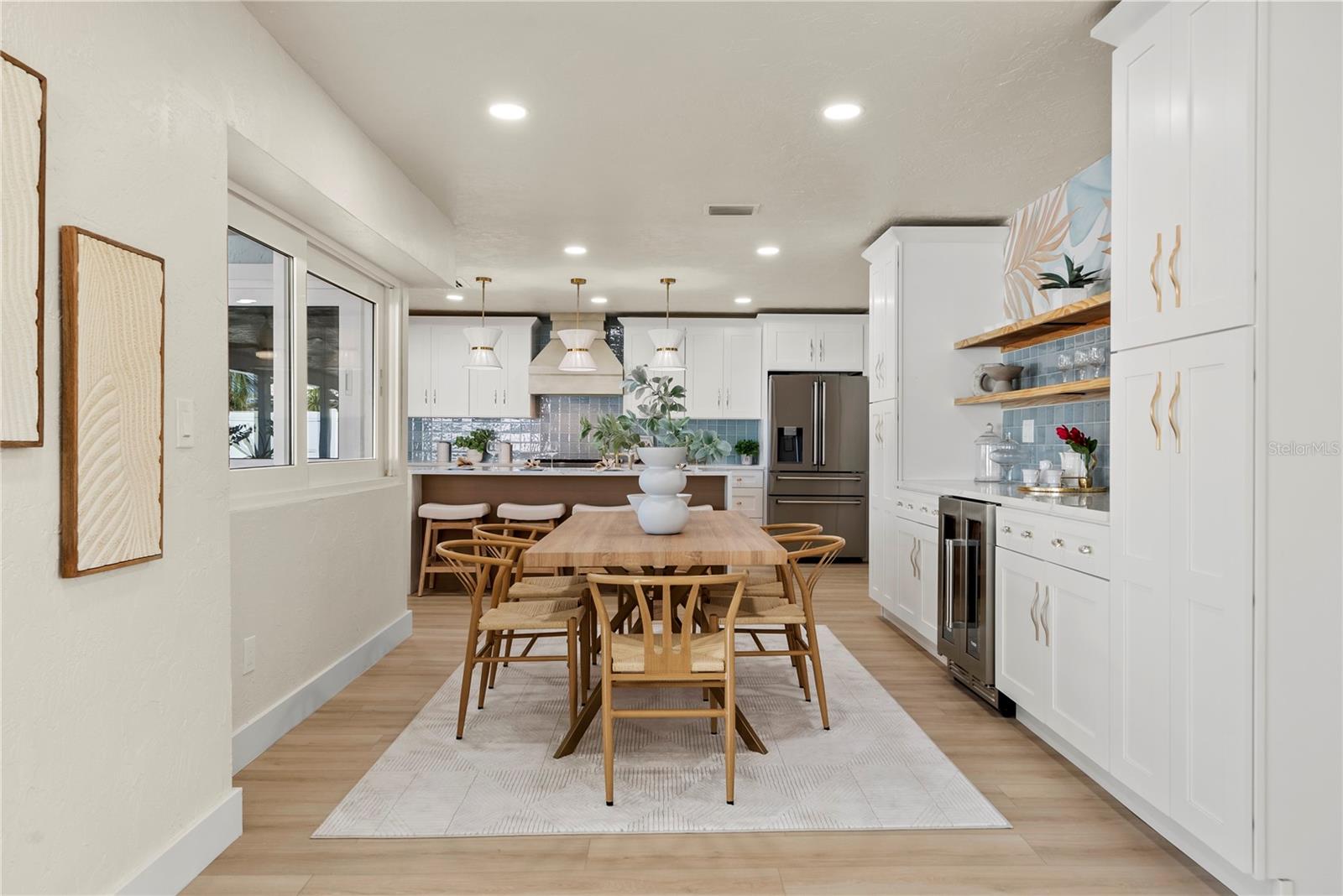 Large Dining area with view of custom entertainment area with wine and beverage fridge