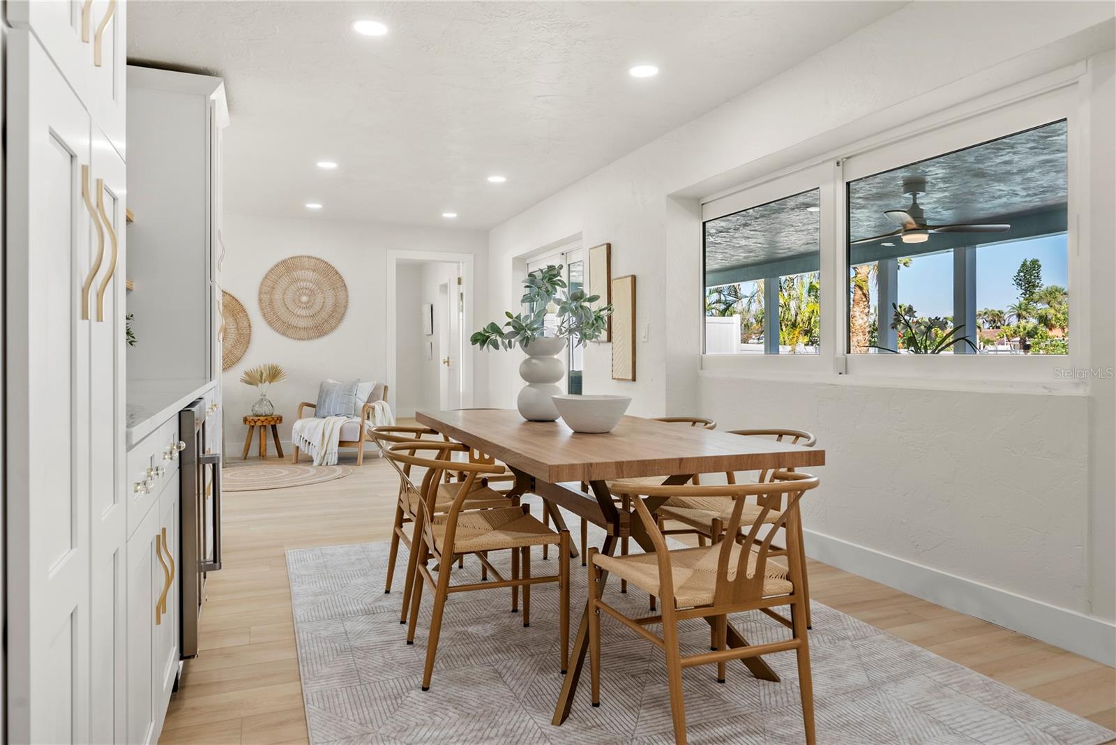 Oversized dining table with window view to covered lanai