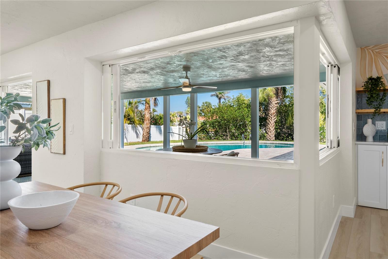 Custom pocketing windows that open entirely to the covered lanai area for ease of entertaining