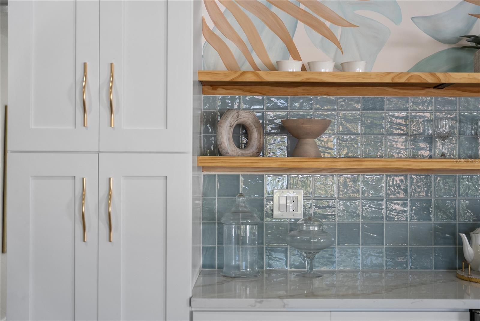 Custom tile with the floating shelves in the entertainment bar area