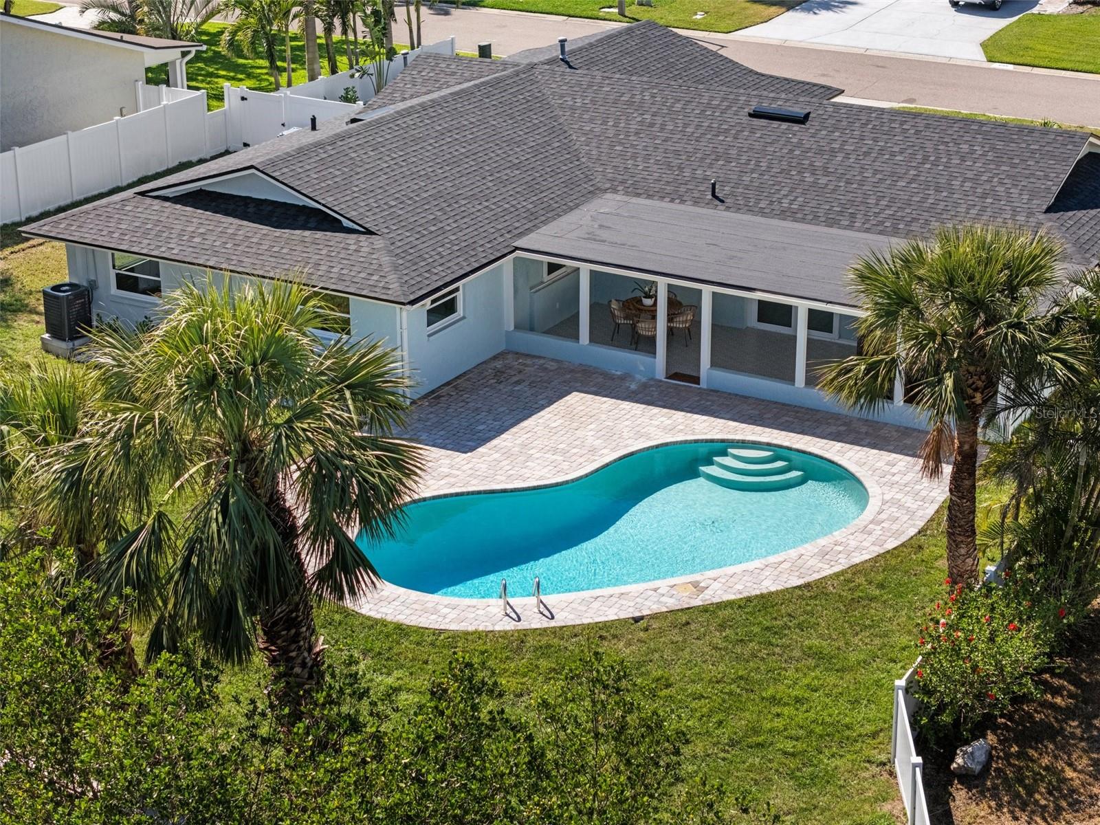 Back of property with a view of the pool and yard