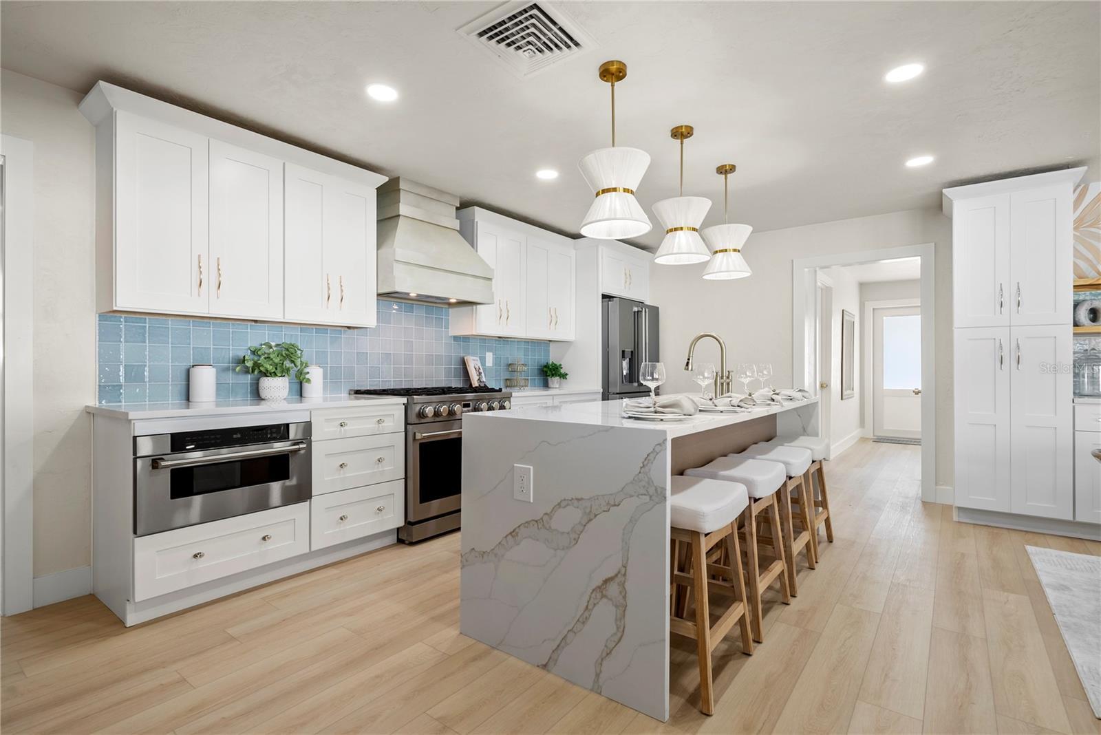 Great shot of the kitchen island with seating at the breakfast bar